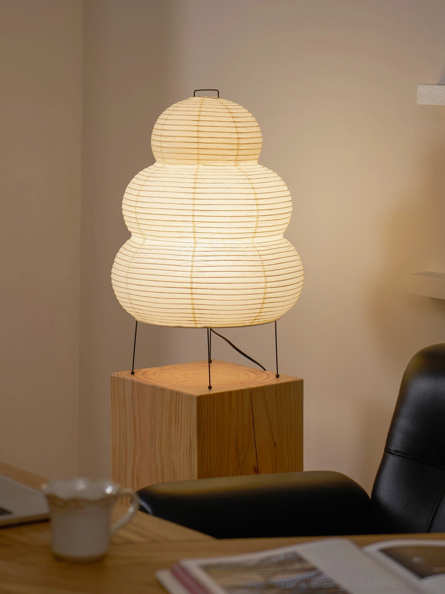 White tiered Shoji paper lamp in ambient home setting, warm contemporary lighting