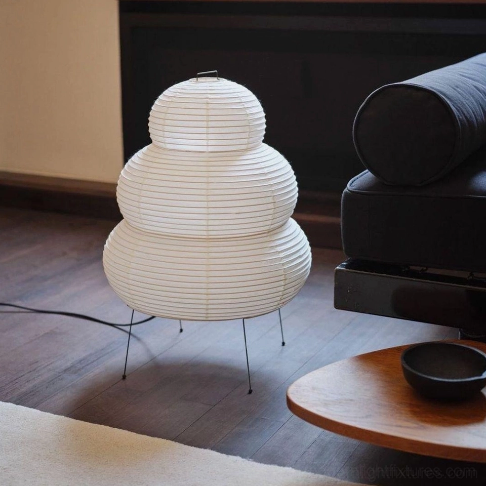 Contemporary tiered table lamp in modern living room beside dark sofa, Japanese-inspired styling