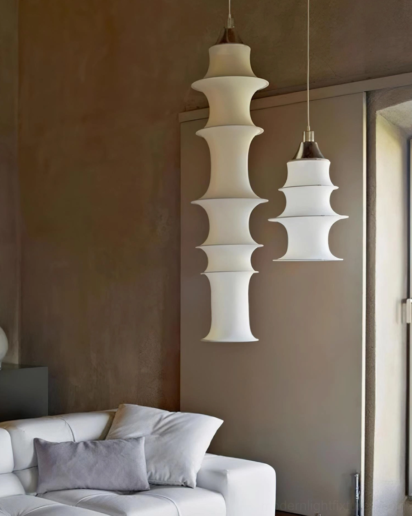 Tiered white fabric pendant light in bedroom corner creating warm intimate ambiance