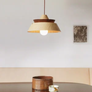Tiered wood pendant lamp hanging above dining table, warm ambient lighting with globe bulb in contemporary interior