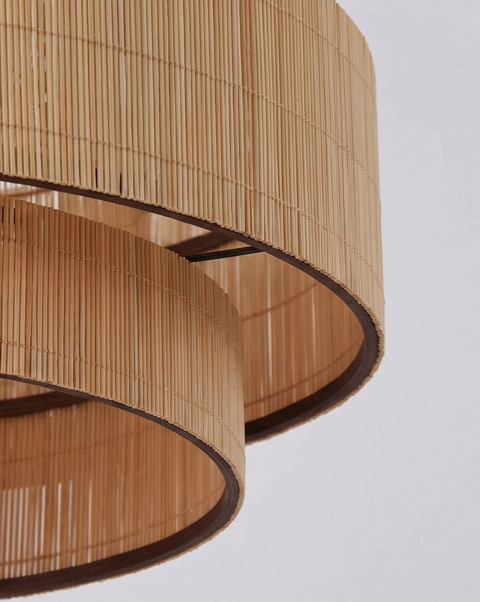 Tierelle woven-bamboo pendant demonstrating scale proportions and shadow play effect through illuminated tiers, atmospheric lighting design