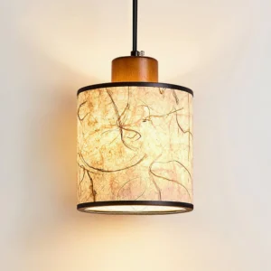 Tierra pendant lamp illuminated showing warm diffused light through semi-translucent handmade rice paper with visible organic fibers