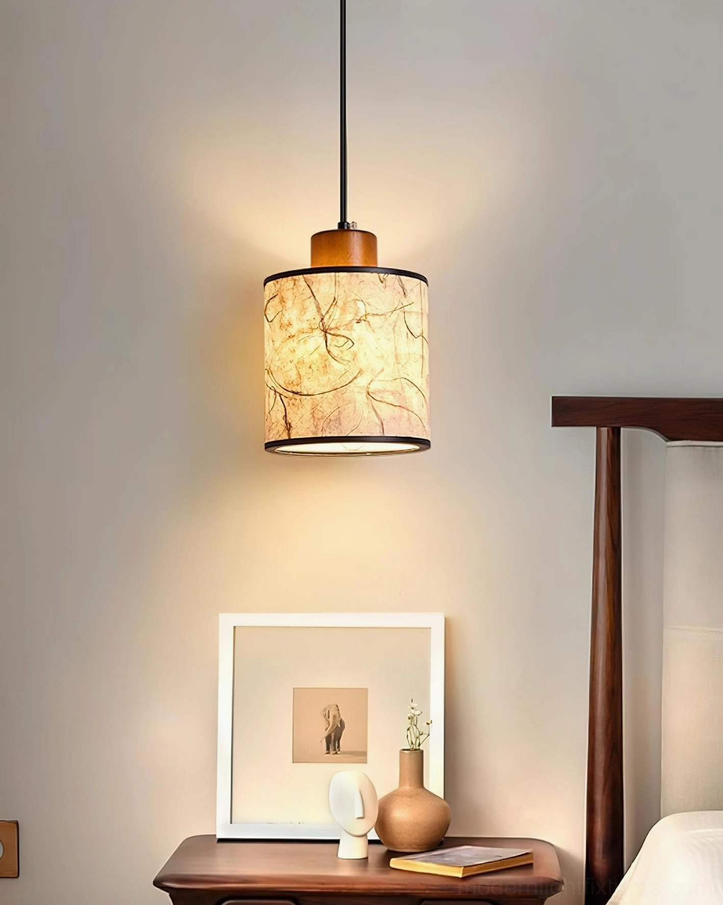 Tierra pendant light close-up in bedroom creating warm atmospheric lighting with rustic organic aesthetic