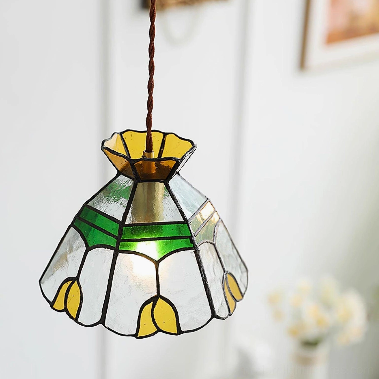Tiffany stained glass pendant light detail view showcasing hand-soldered joints, colored glass tiles, and vintage brass frame