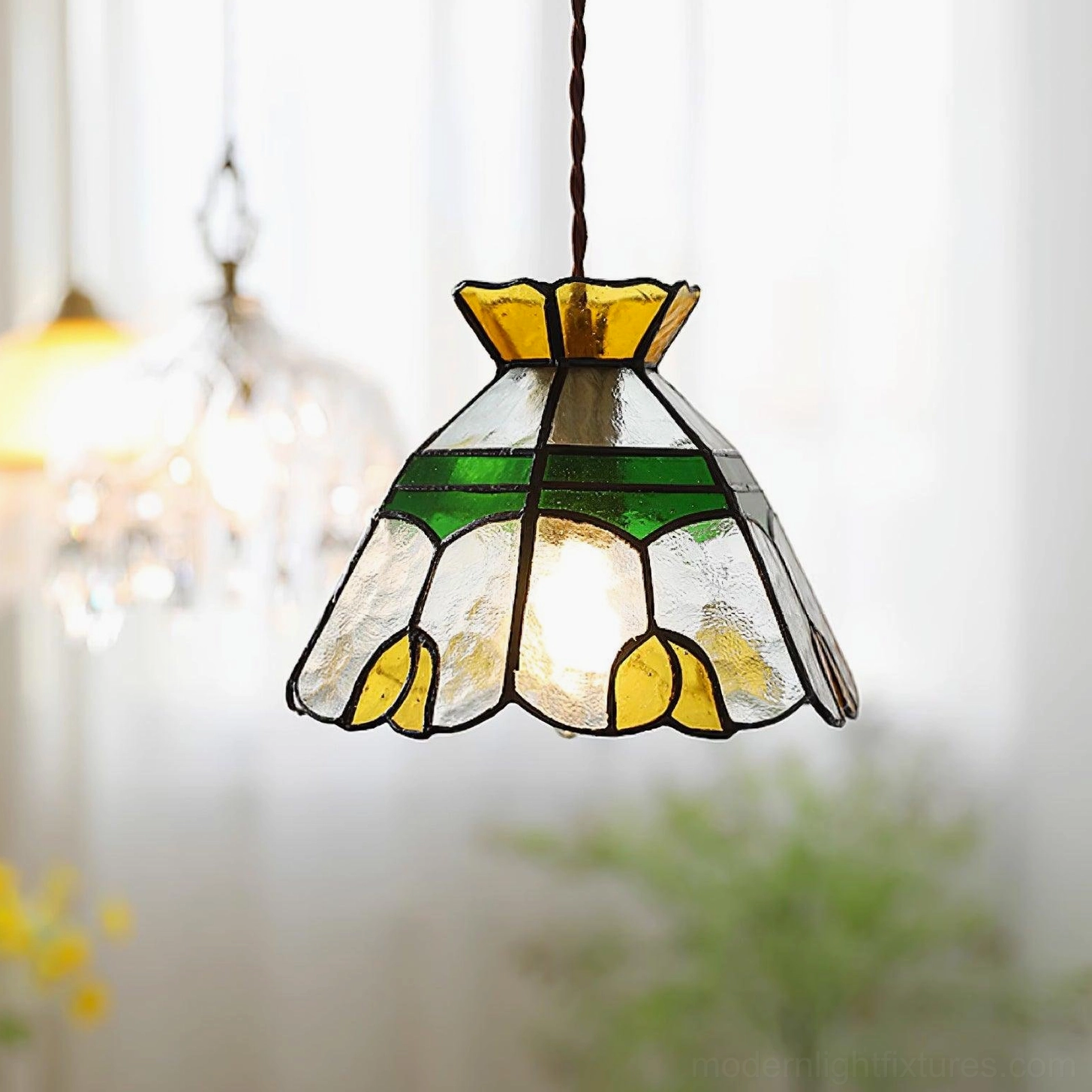 Mounted Tiffany stained glass pendant fixture showing installation details, brass mounting hardware, and colored glass shade assembly