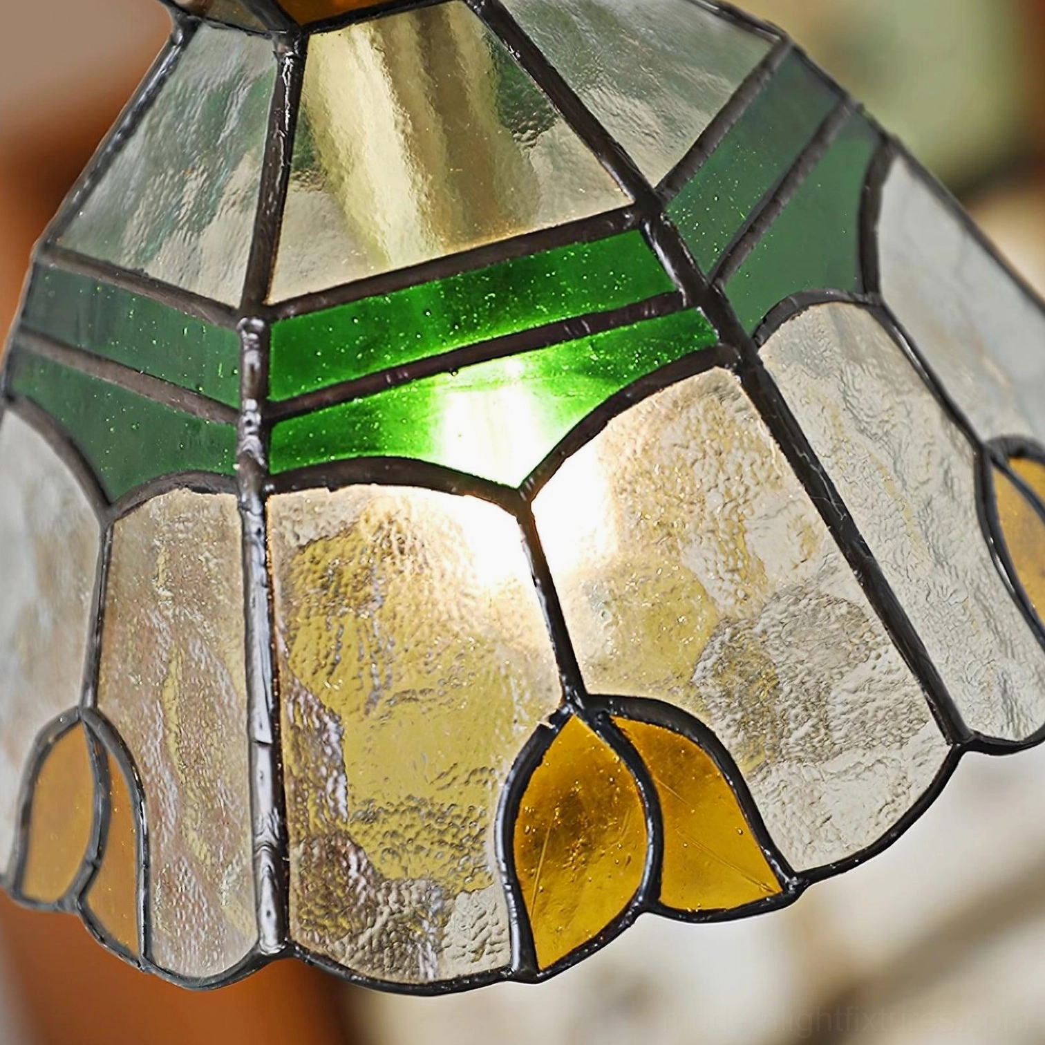 Tiffany stained glass pendant light artistic composition showing colored glass shade design, brass hardware, and suspension cord