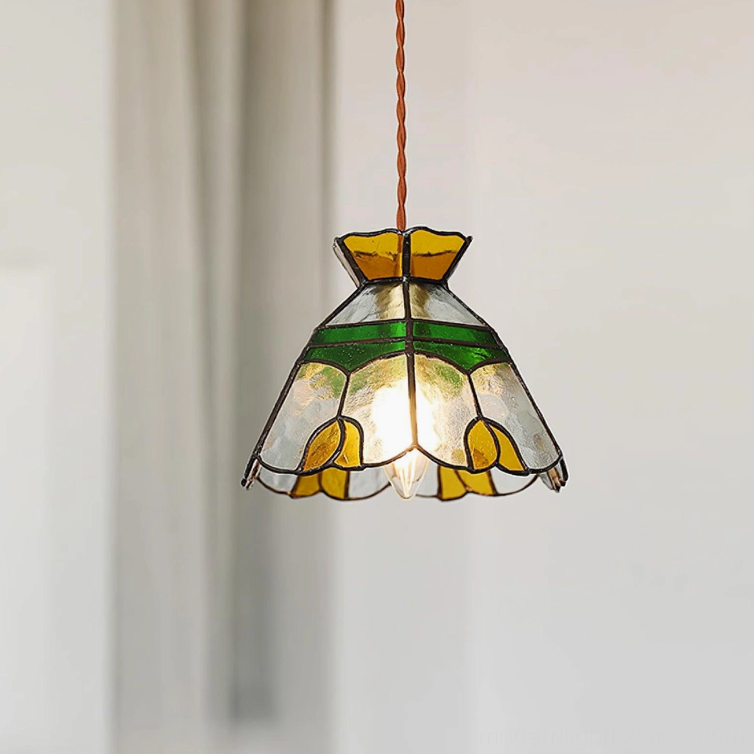 Tiffany pendant lamp with artistic stained glass shade in eclectic bohemian home interior, warm ambient lighting