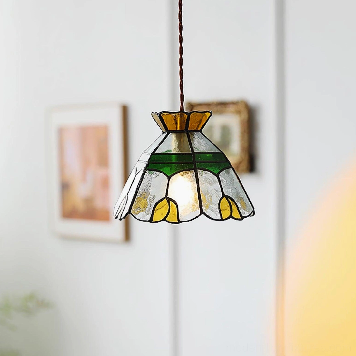 Tiffany vintage stained glass pendant lamp creating warm atmospheric lighting with jewel-toned colored glass in home setting