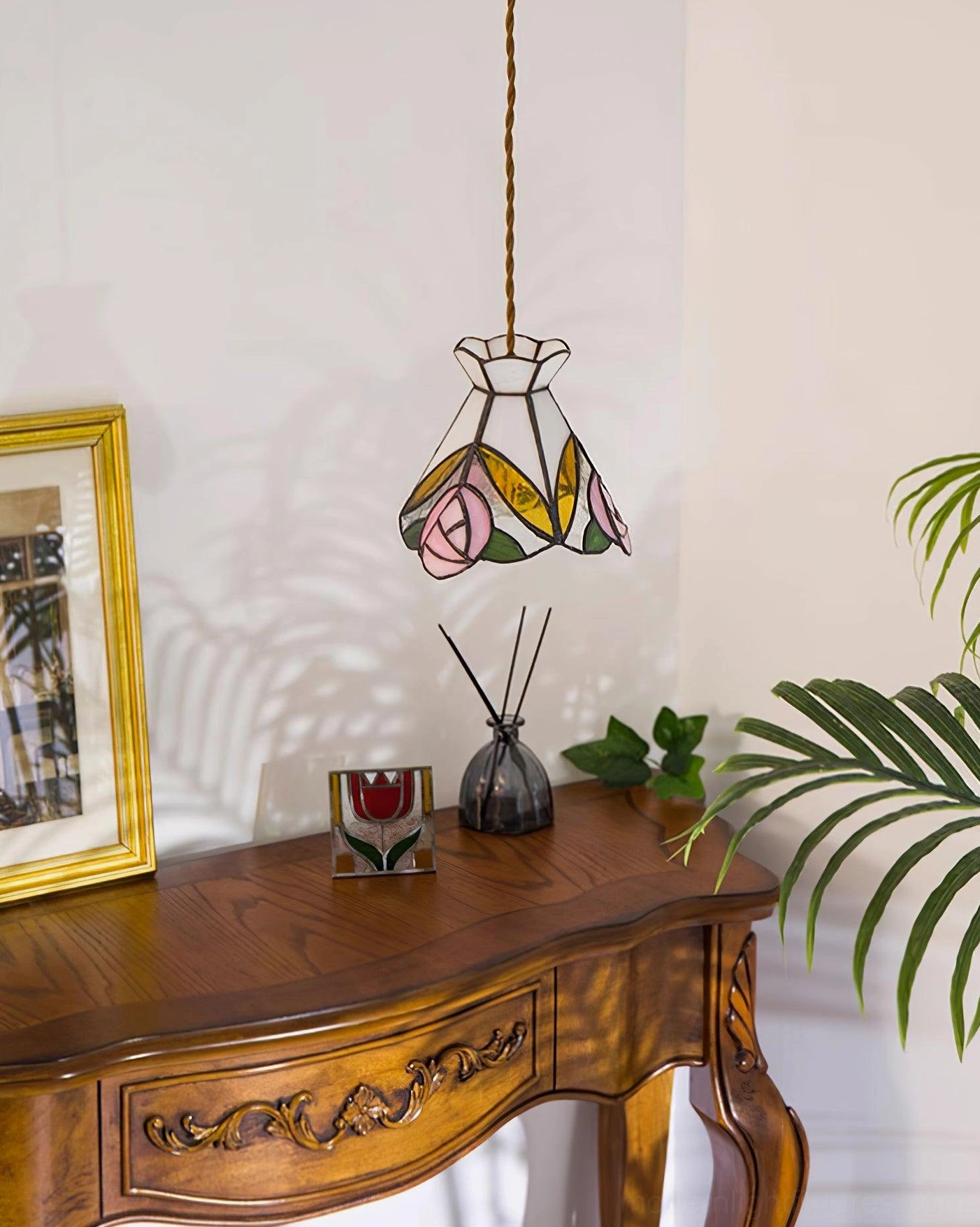 Artistic rose motif in Tiffany pendant lamp showcasing delicate botanical stained glass design