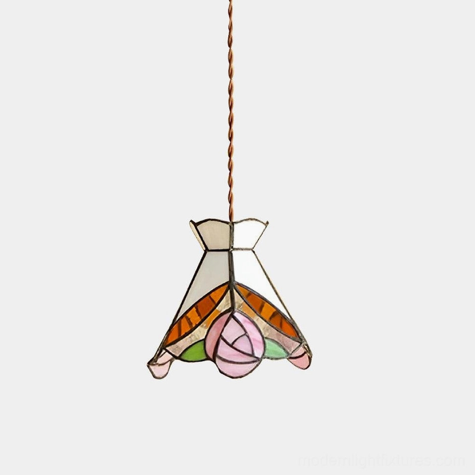 Vintage Tiffany rose stained glass pendant light with warm brass fixtures and delicate floral design, studio overhead view