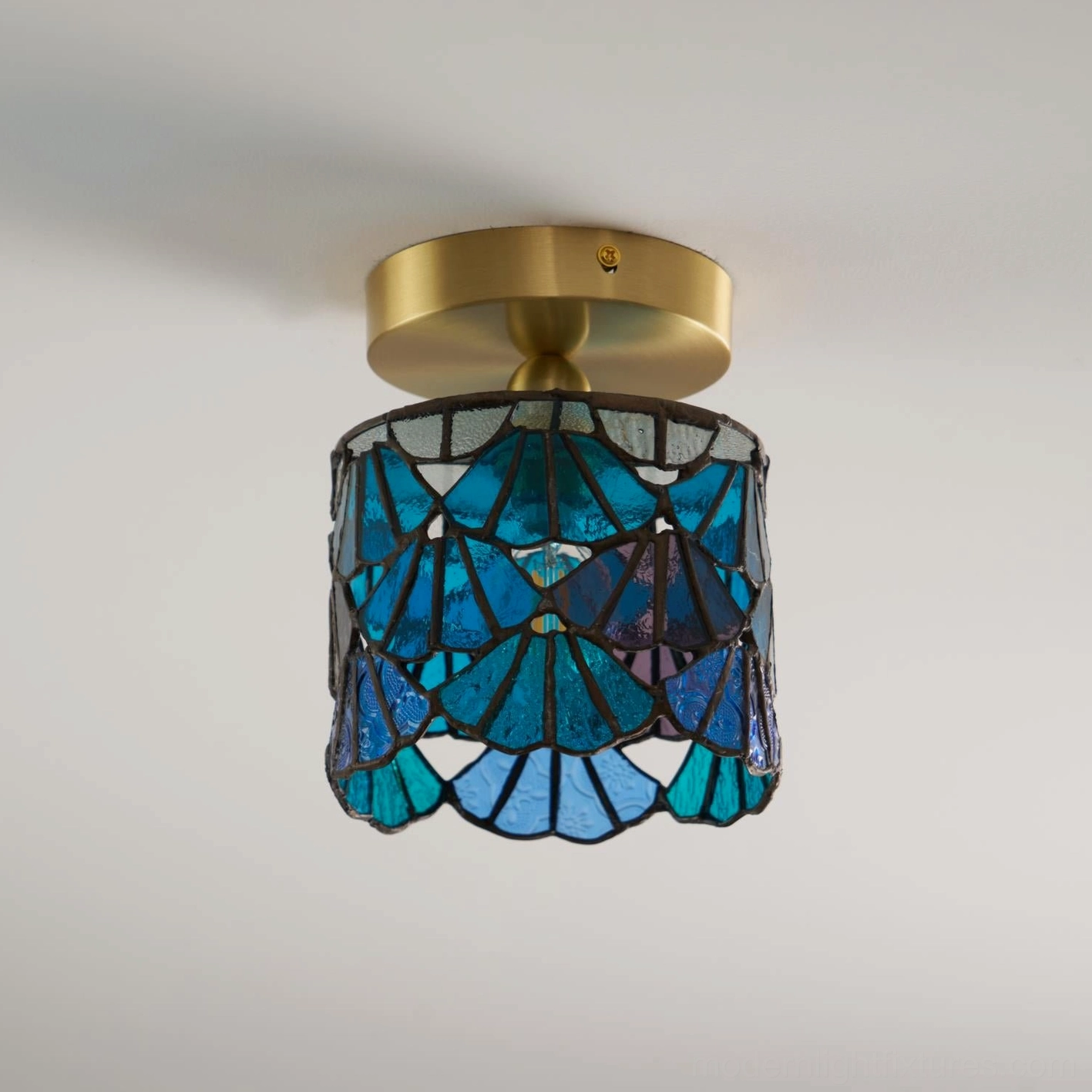 Close-up of Tiffany stained glass shade showing detailed lead-line construction and texture