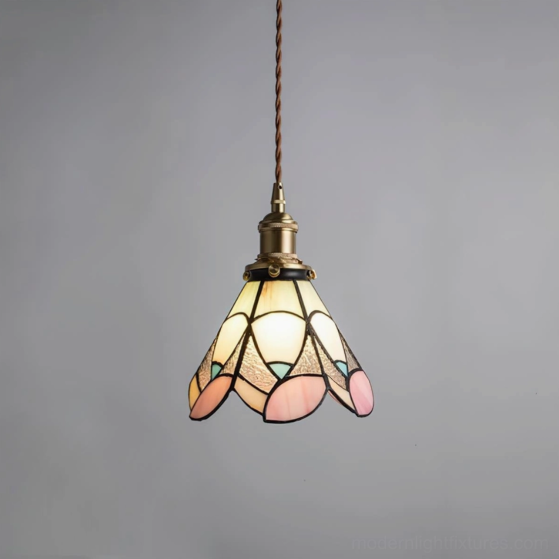 Tiffany style stained glass pendant featuring intricate botanical pattern in jewel tones with brass hardware