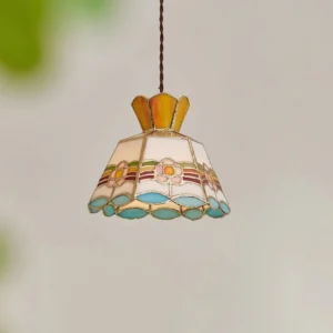 Close-up detail of Tiffany stained glass pendant showing crown-shaped trim and colored glass panels