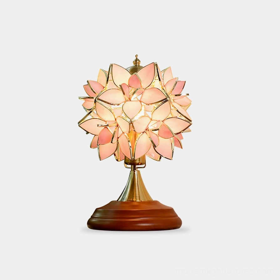 Handcrafted Tiffany stained glass table lamp with pink petal shade and brass wooden base, front view studio shot
