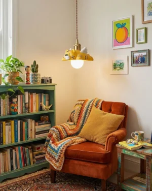 Modern winged tiger pendant lamp hanging in bohemian reading lounge with vintage armchair and bookshelves