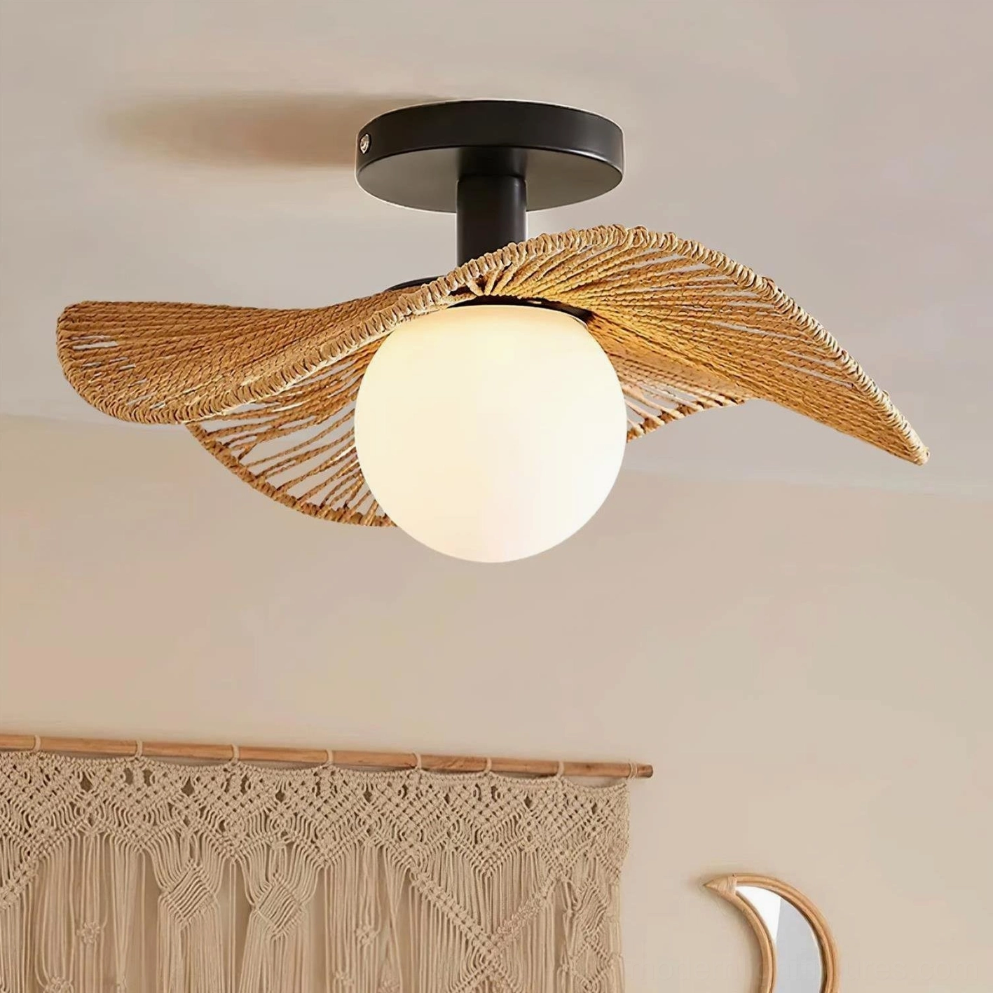 Tilda bohemian rattan ceiling light fixture installed in eclectic interior with macrame wall hanging and crescent mirror, three-quarter angle