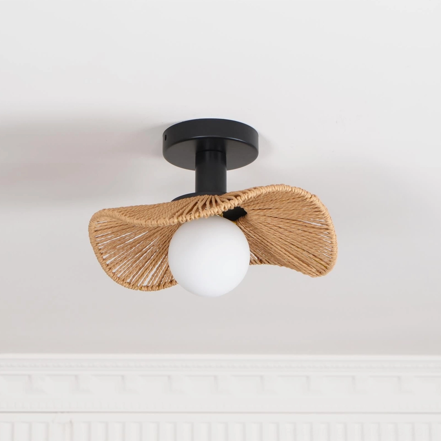 Tilda medium-size rattan ceiling light fixture mounted in contemporary home setting with warm lighting