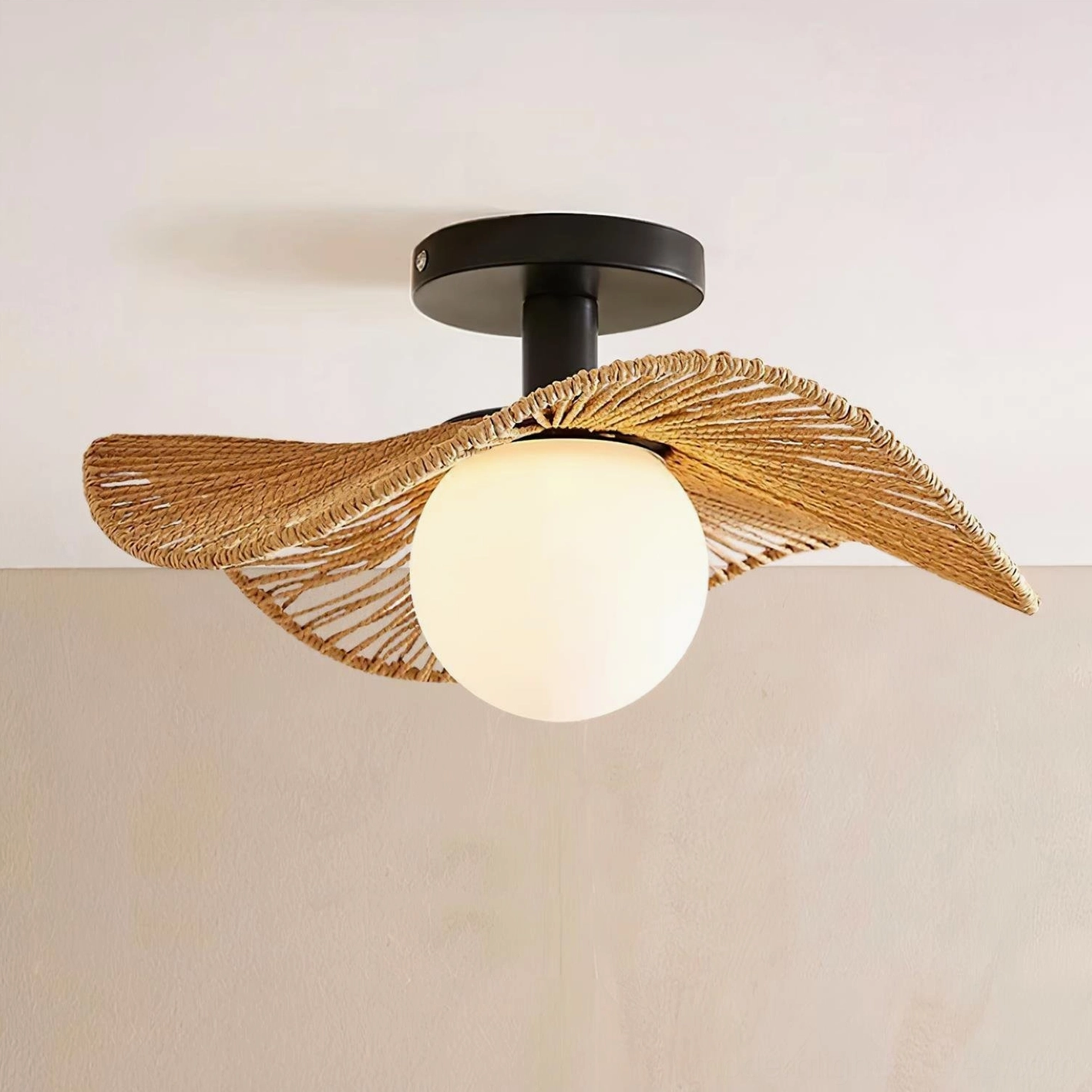 Tilda natural woven rattan ceiling light with matte black ceiling mount and frosted glass bulb cover, flat front perspective