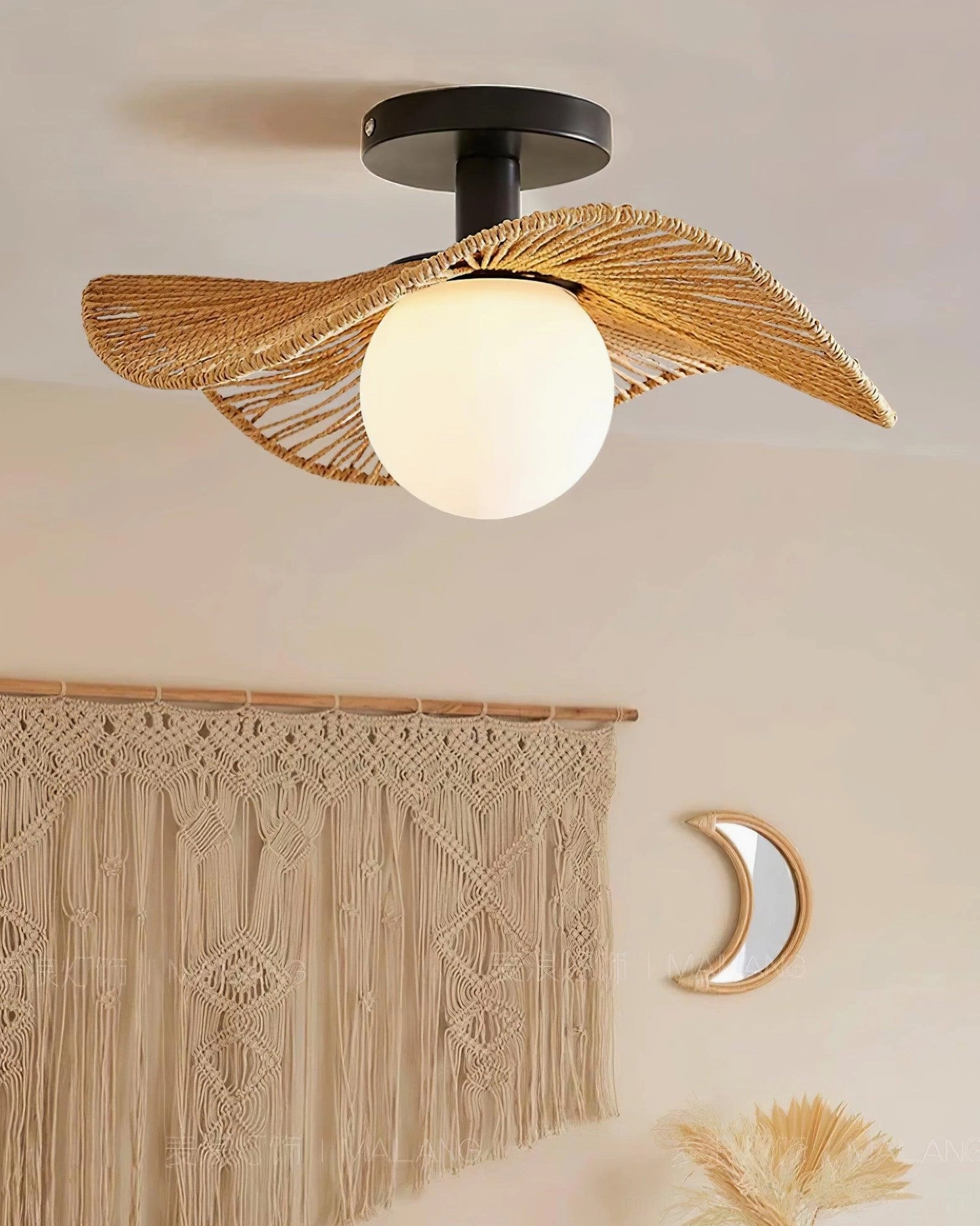 Tilda rattan ceiling light with natural leaf shade and frosted glass lamp shade, three-quarter front view with macrame tapestry