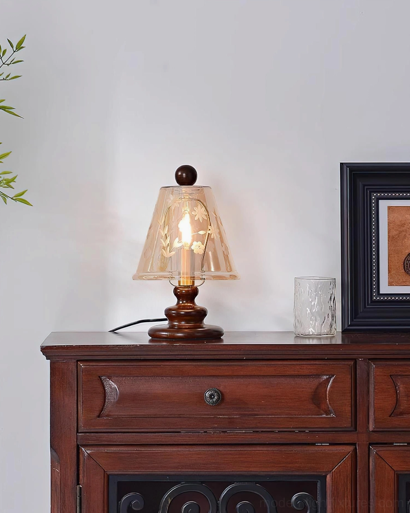 Tilda table lamp with etched floral cognac glass shade and matching decorative vessel on carved wooden dresser top