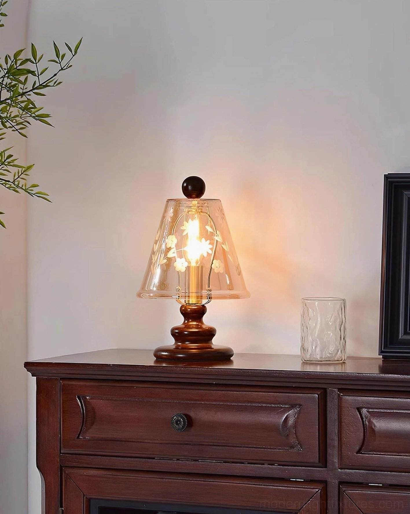 Tilda vintage table lamp with lit filament bulb, three-quarter front view on small wooden dresser