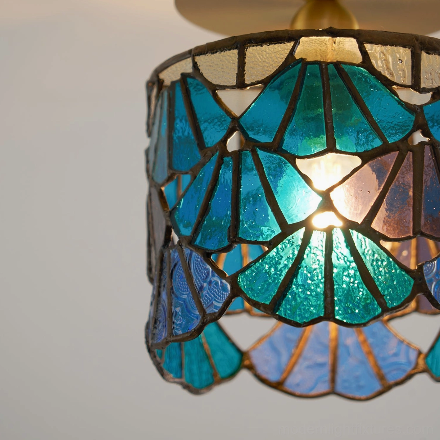 Tina Tiffany ceiling fixture mounted in bedroom corner creating ambient colored light atmosphere