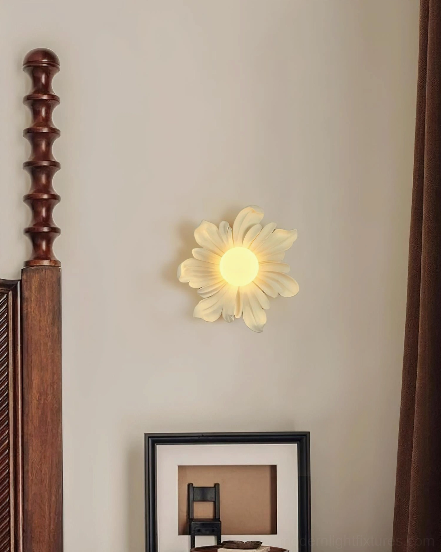 Off-white Tina flower wall sconce mounted on bedroom bedside wall, minimalist pale petal design with warm illumination