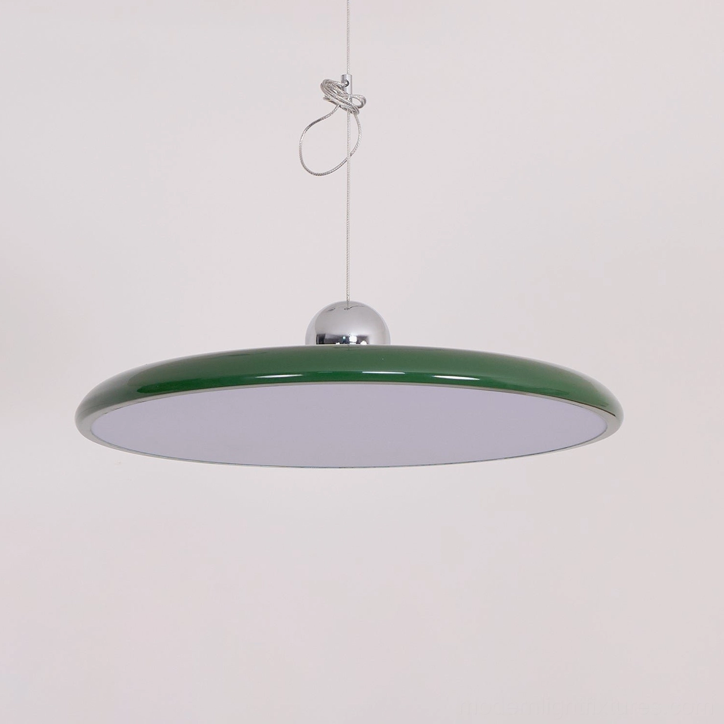 Chrome finished Tizio disc pendant lamp reflecting light on modern sculptural form