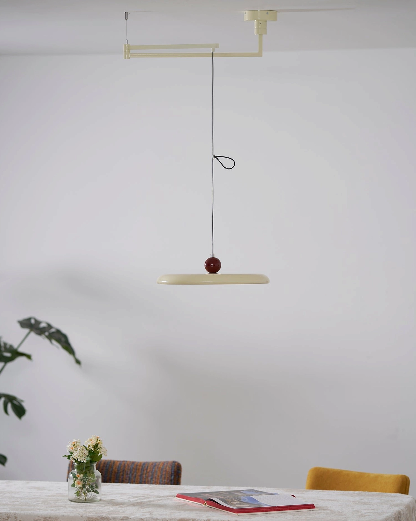 Multiple Tizio disc pendant lights in different colors creating cohesive lighting design