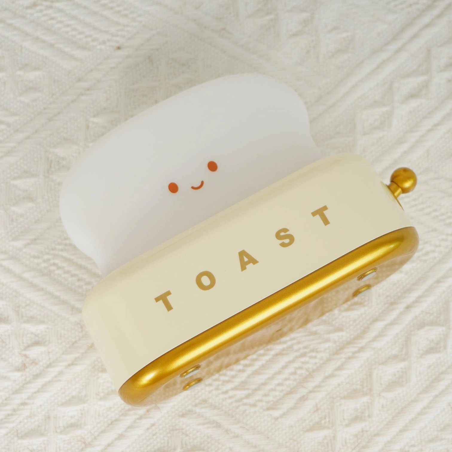 Toaster table lamp with brass power knob detail showing thoughtful design and tactile control