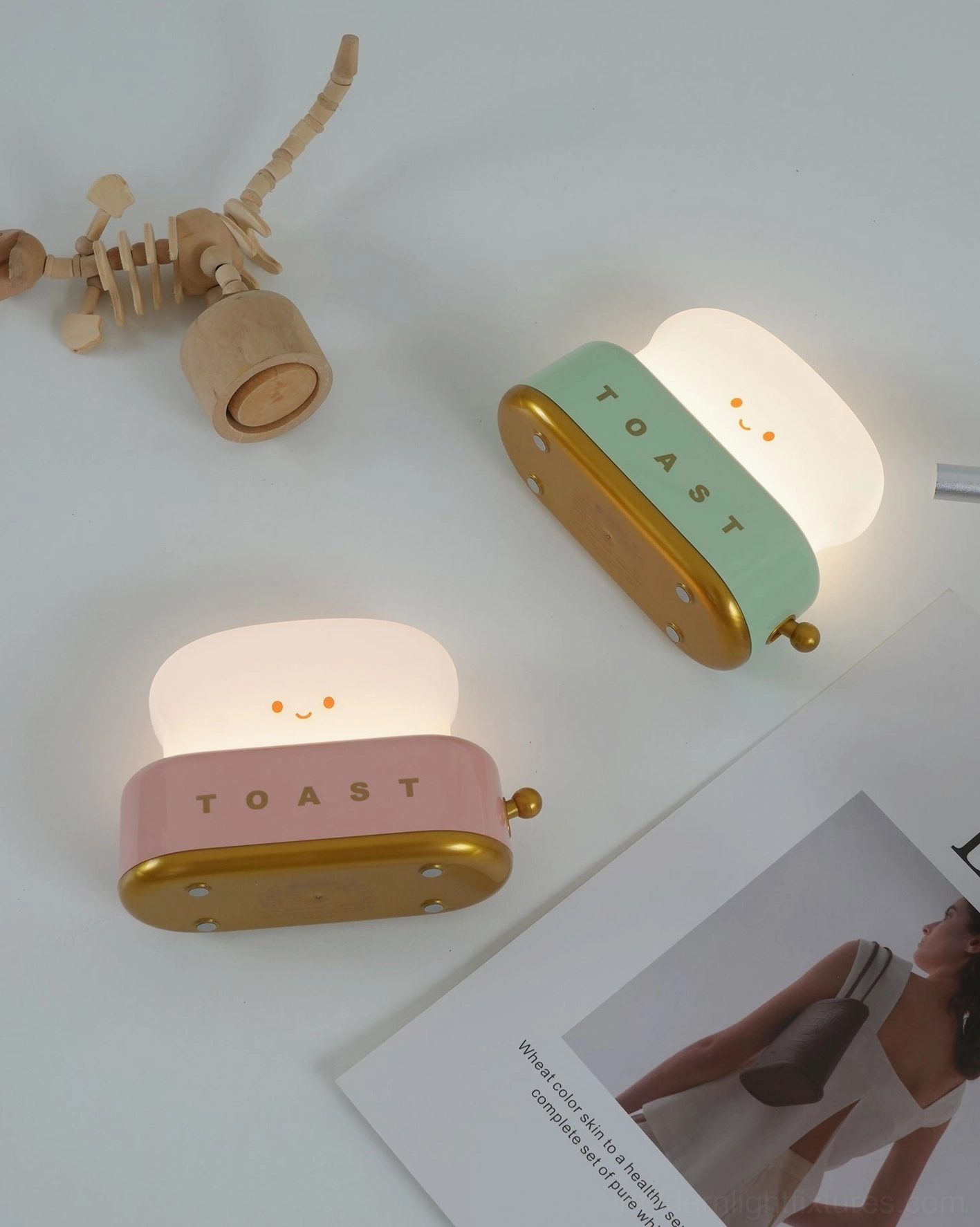 Multiple toaster table lamps in different colors arranged on display shelf showing design versatility