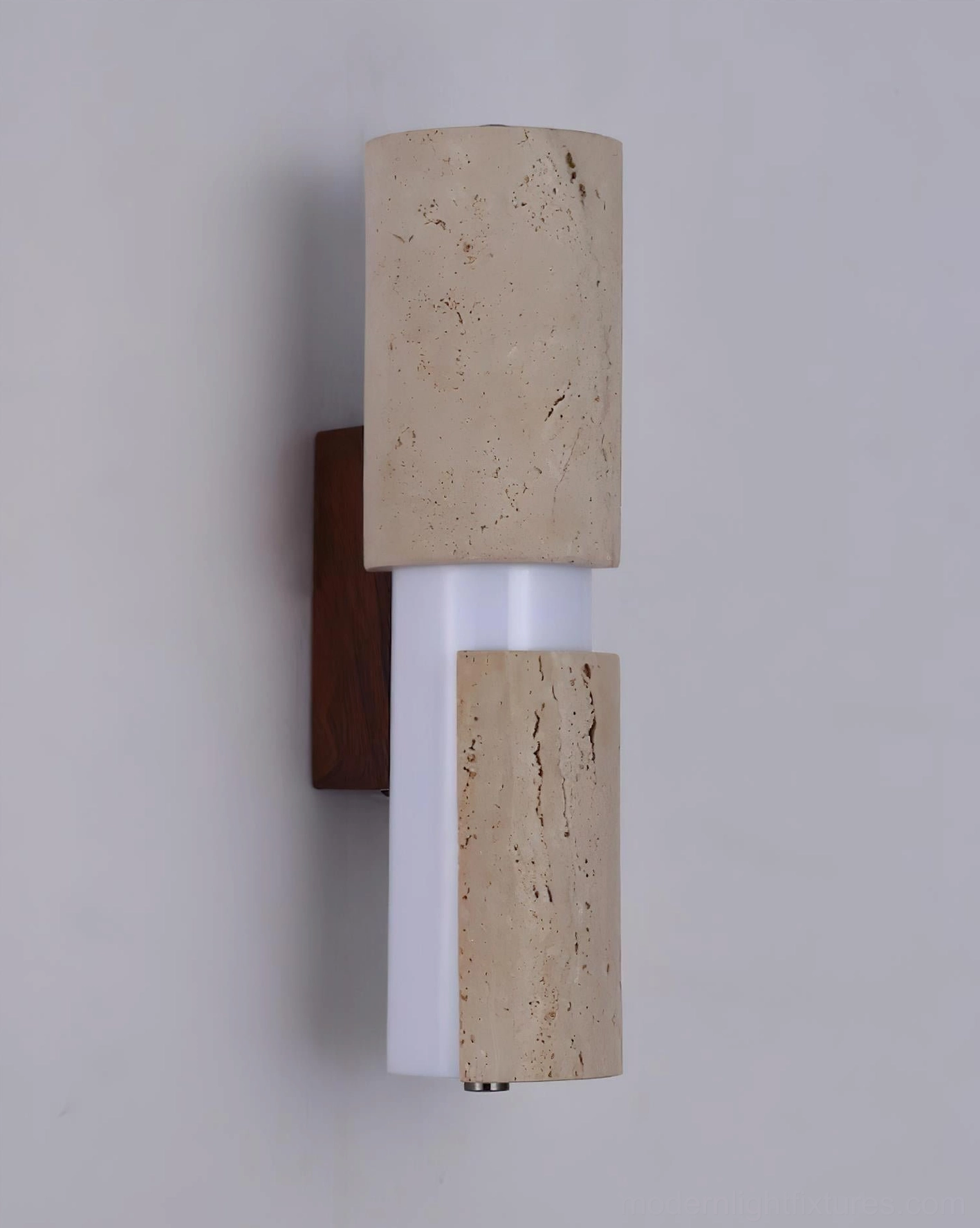Tolira travertine sconce lit at night, 3000K warm white LED creating intimate residential ambiance