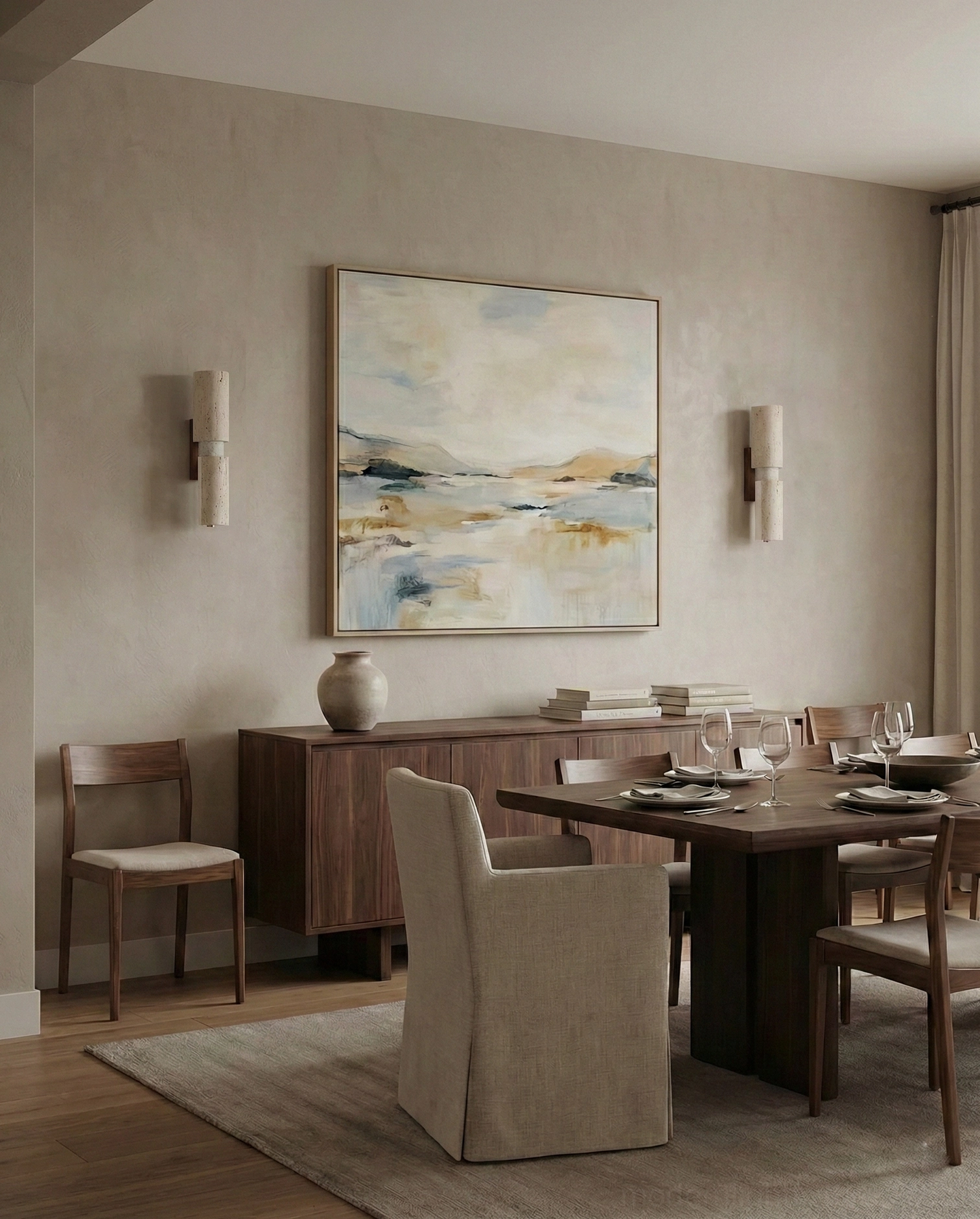 Two Tolira travertine sconces flanking wall art in dining room, creating gallery-style sophisticated rustic illumination