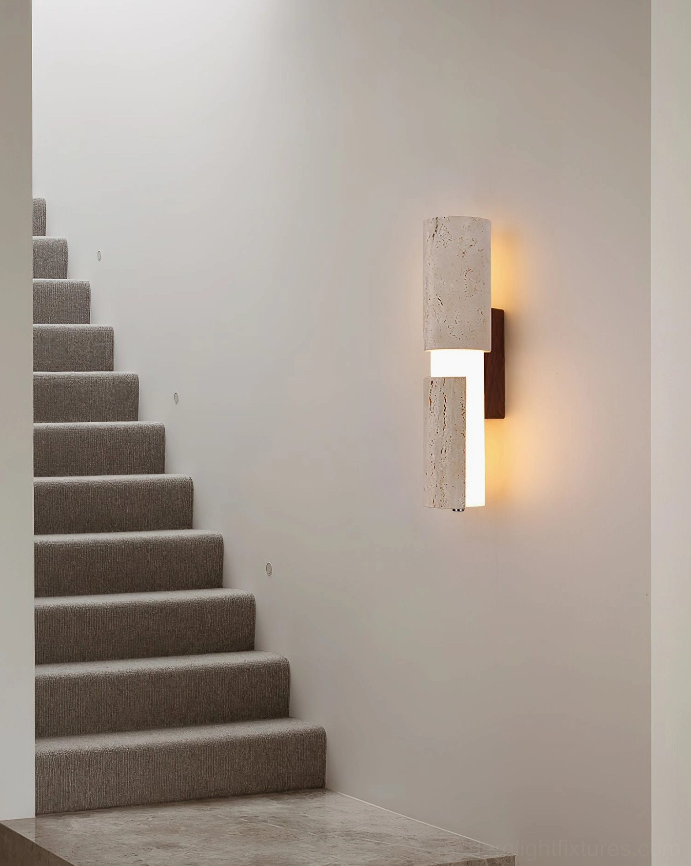 Tolira travertine wall sconce, styled flat-lay product photography showing complete fixture composition
