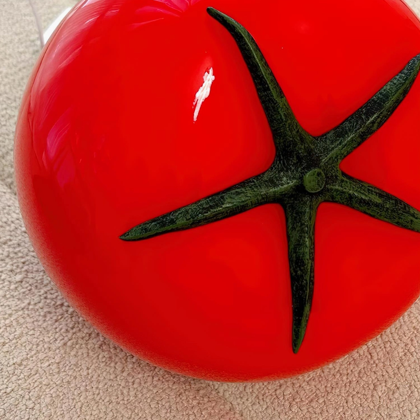 Decorative tomato glass lamp in luxury home setting with refined styling and accessories