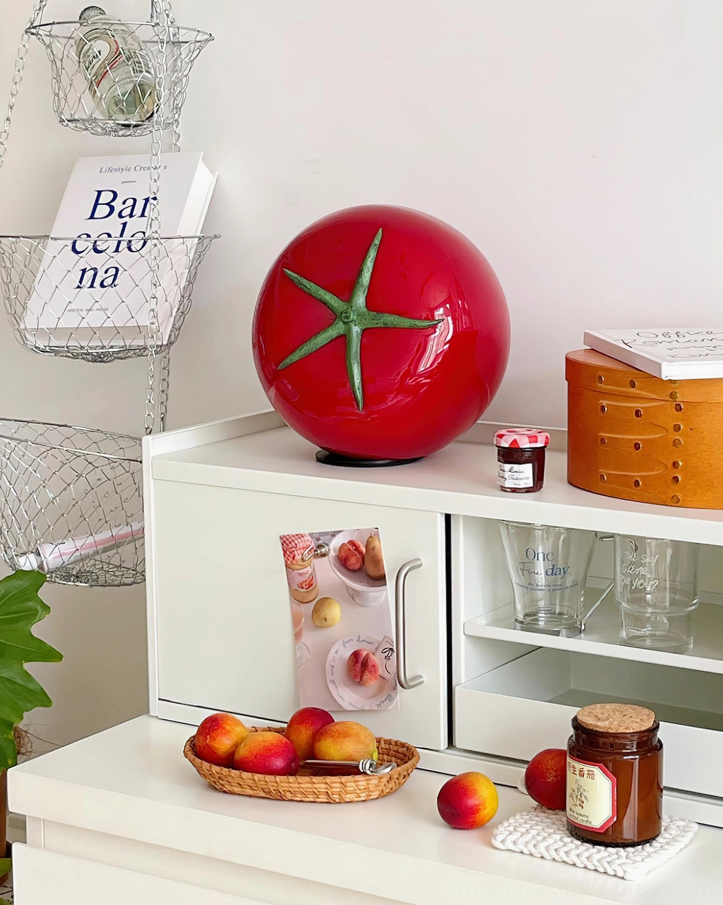 Red tomato glass lamp in kitchen setting surrounded by fresh produce and storage boxes - modern farmhouse lighting
