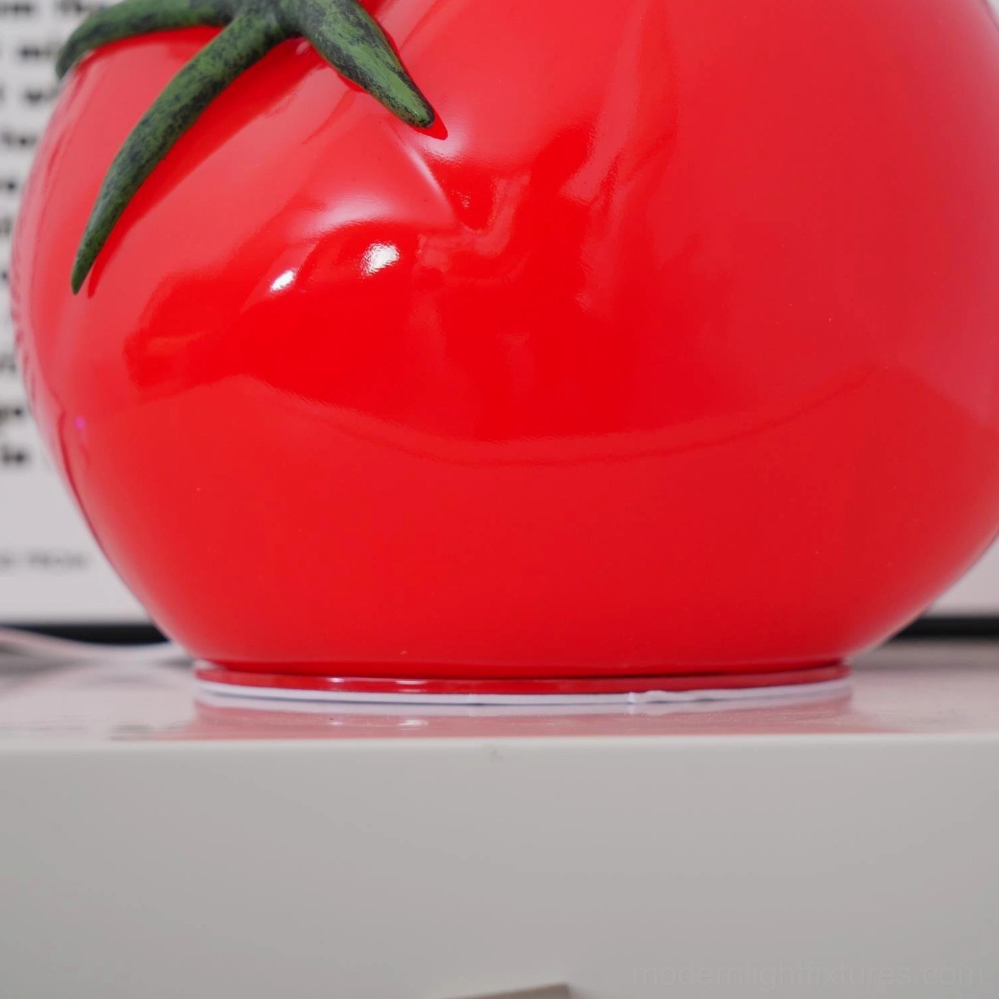 Tomato resin table lamp glossy finish reflects ambient light dimensional form