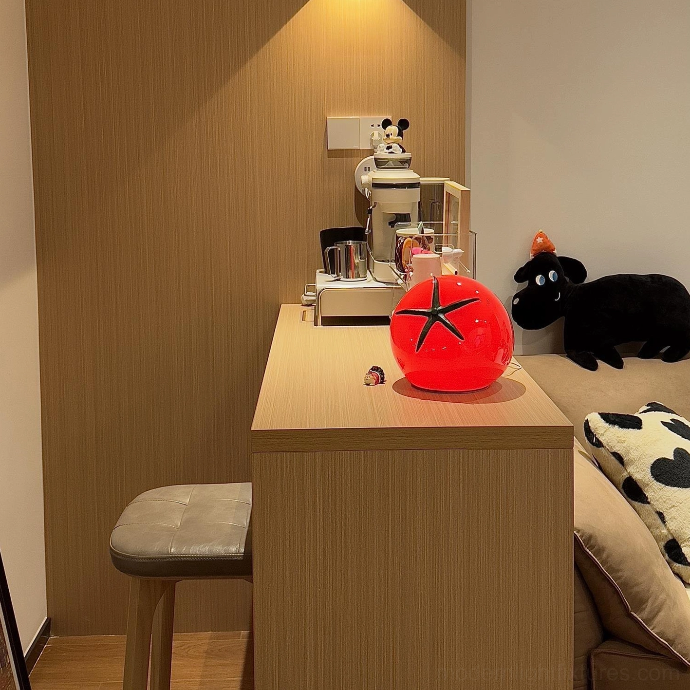 Modern tomato resin table lamp on home office wooden desk with black plush toy styling