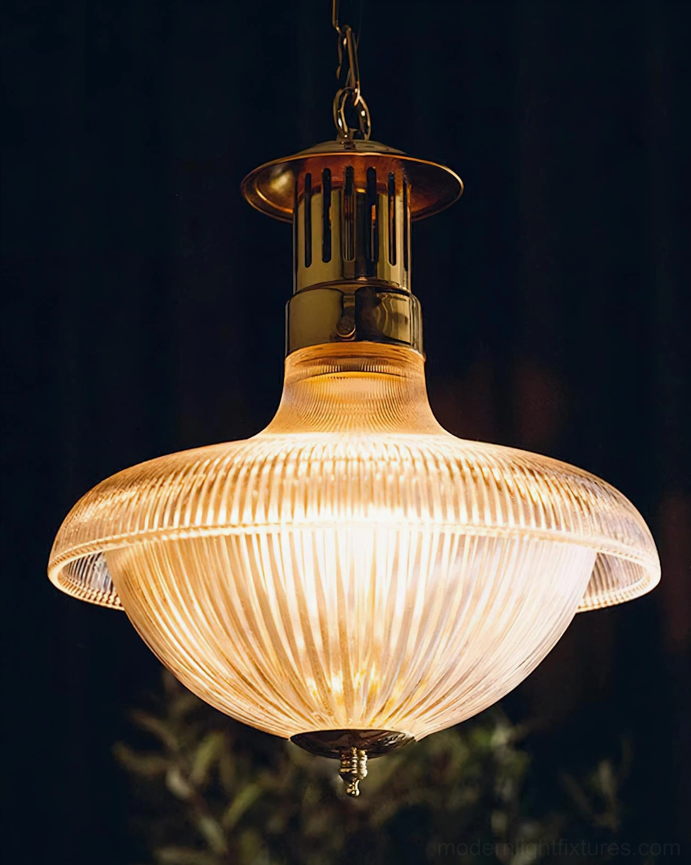 Illuminated Torill vintage pendant lamp with warm amber glow from ribbed glass shade, indoor ambient lighting