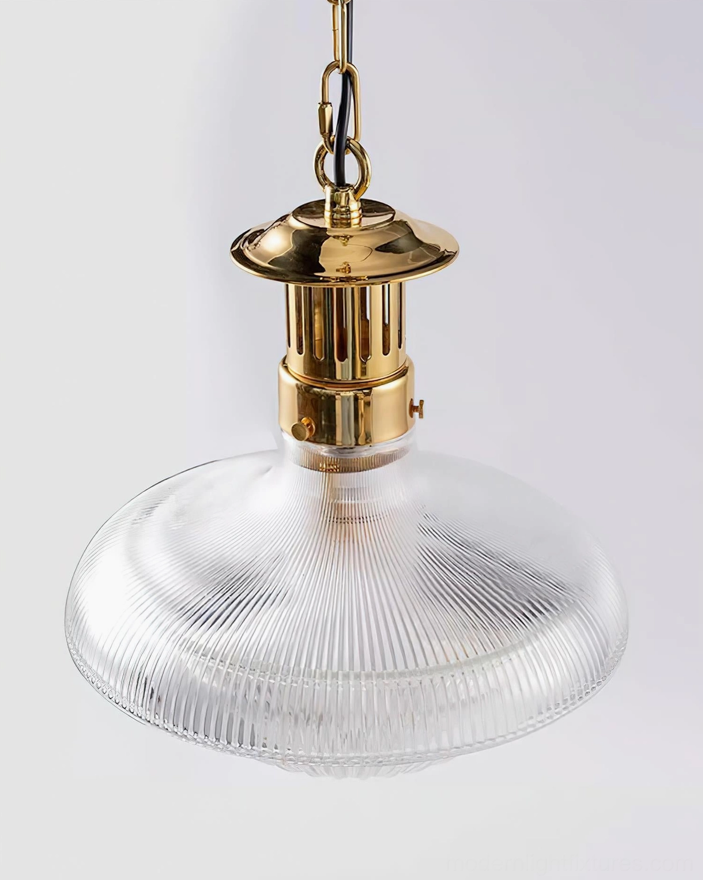 Torill pendant light frontal close-up showing smooth clear ribbed glass body and flat round brass ceiling mount