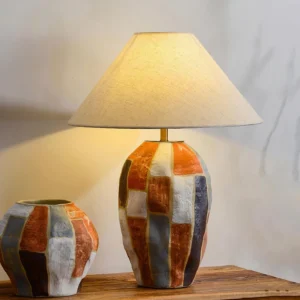 Torino colorful white ceramic table lamp with matching decorative jar on wooden tabletop with warm lighting