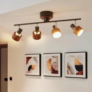 Adjustable track lighting fixture installed in modern living room with warm ambient illumination and wall art
