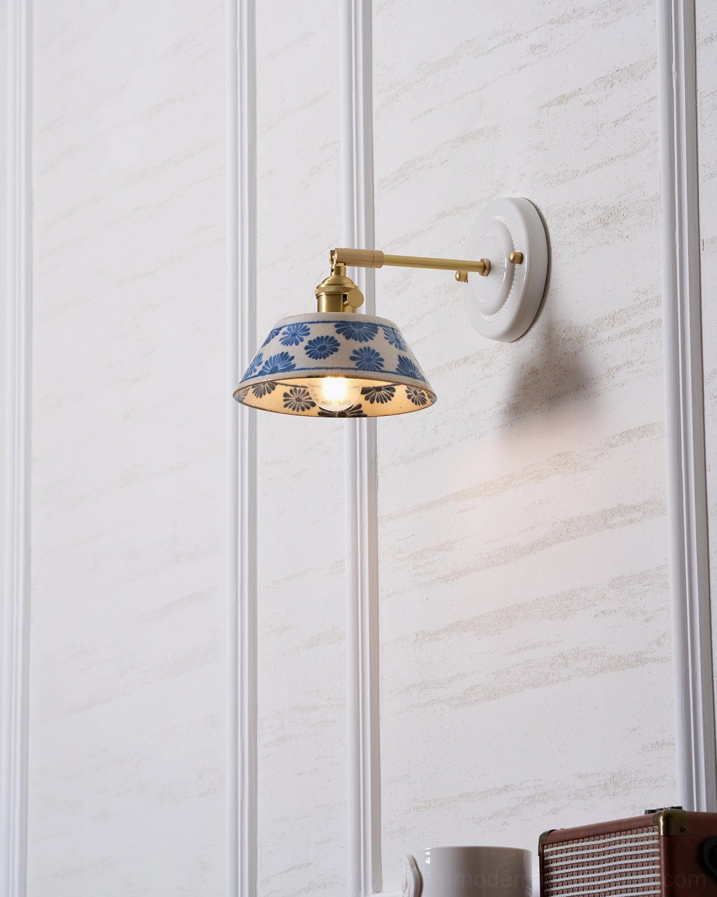 Indigo ceramic wall sconce showcasing traditional porcelain glaze and modern mounting
