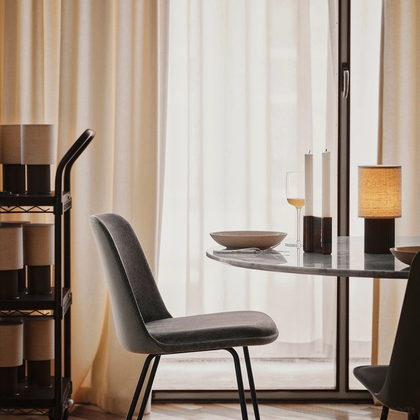 Minimalist wireless charging table lamp with fluted base and fabric shade, transitional interior lifestyle photography blending traditional and contemporary