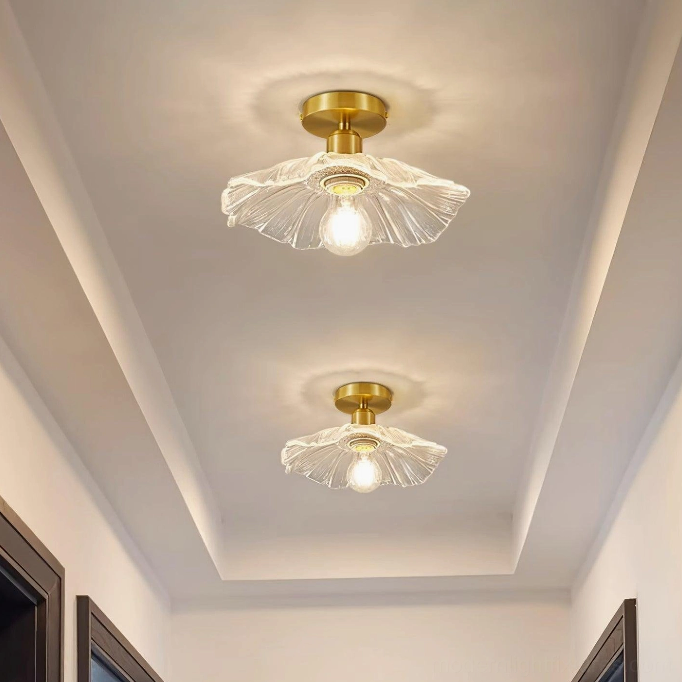 Ruffled glass ceiling light fixture showcasing translucent clear shade design and vintage-inspired brass mount