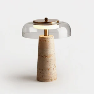Close-up of travertine base table lamp showing natural stone texture, integrated LED glow, and glass shade detail