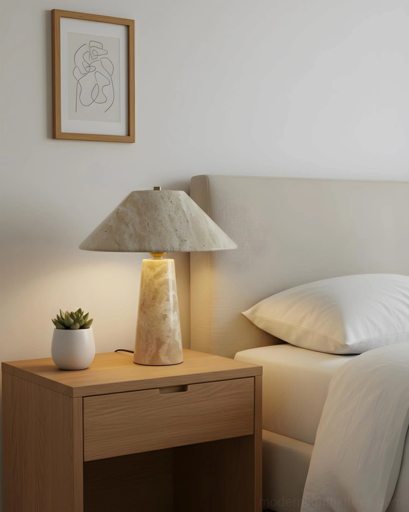 Travertine bedside table lamp on light wood nightstand with small potted plant in serene master bedroom