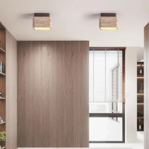 Pair of travertine flush mount ceiling lights installed in contemporary home study with warm wood tones