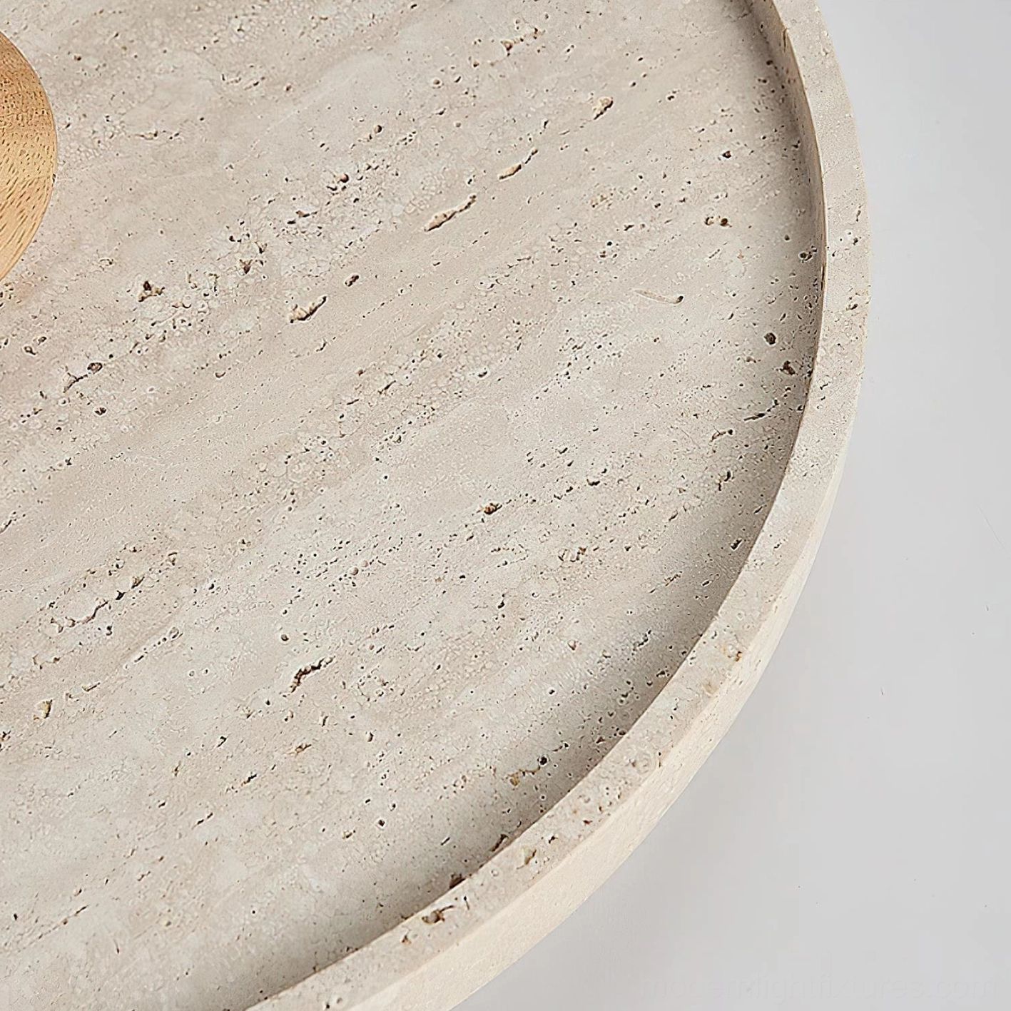 Travertine round ceiling light illuminating modern minimalist living space