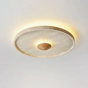 Modern travertine flush mount ceiling fixture with warm ambient glow, angled overhead view